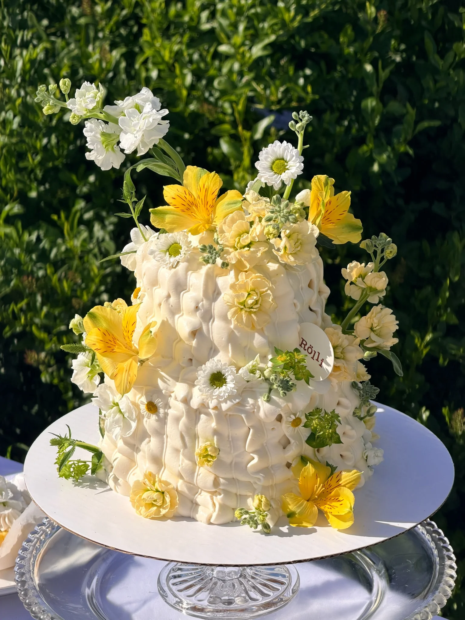 White textured cake decorated with yellow flowers