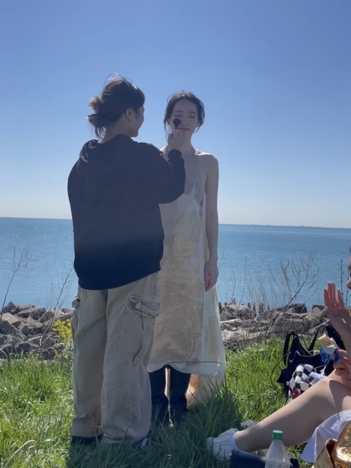 Vicky doing makeup by the lake